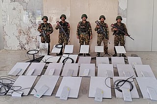 In this image provided by the Myanmar military on Oct. 19, 2025, soldiers stand next to Starlink machines as they seize KK Park online scam center in Myawaddy township, Karen State, Myanmar.