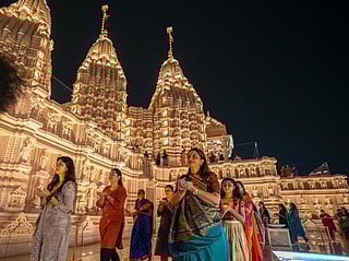 Women take part in the Diwali prayers at the BAPS Hindu Mandir in Abu Dhabi on Monday night. 