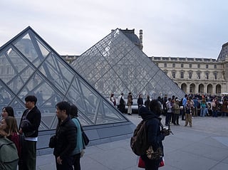 Visitors queue to enter the Louvre museum three days after historic jewels were stolen in a daring daylight heist, Wednesday, Oct. 22, 2025 in Paris. 