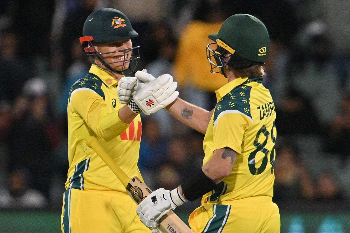 Australis’s Cooper Connolly (L) and Adam Zampa celebrate their win during the second one-day international (ODI) men's cricket match against India at the Adelaide Oval in Adelaide on October 23, 2025.