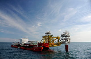 A picture shows Caspian Stream tanker near the Russian LUKOIL ice-resistant fixed platform LSP-1, built at the Astrakhansky Korabel shipyard, intended to drill and operate wells and collect and pre-treat reservoir content at Korchagin's oil field in the Russian sector of the Caspian Sea some 180 km outside Astrakhan. File photo taken on taken on April 9, 2011.