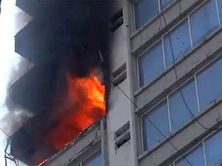 Visuals from the scene showed people stranded on the top floor of the commercial building as firefighters worked to rescue them.