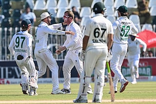 South Africa's Simon Harmer (C) celebrates with teammates after taking the wicket of Pakistan's Mohammad Rizwan during the fourth day of the second Test cricket match at the Rawalpindi Cricket Stadium in Rawalpindi on October 23, 2025.