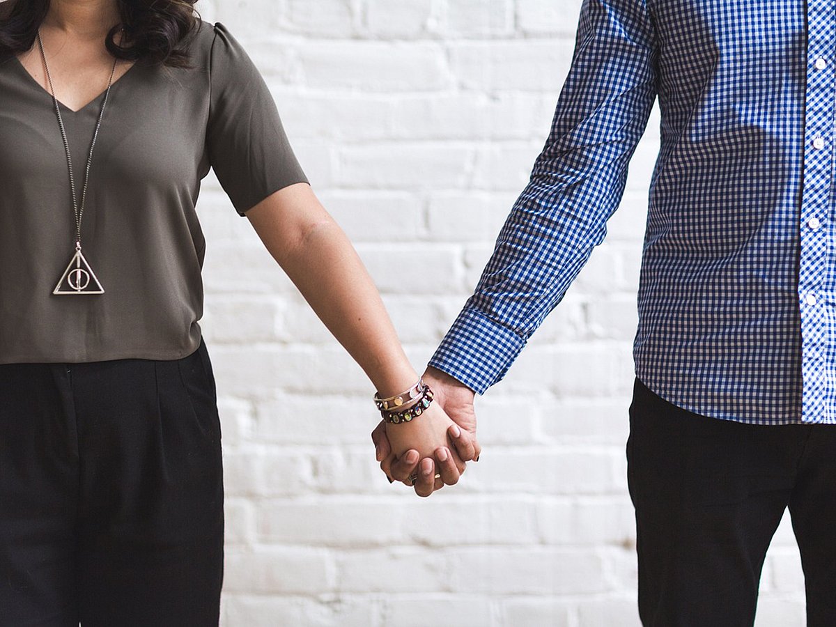 Fertility treatment couple holding hands