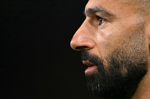 Liverpool's Egyptian striker #11 Mohamed Salah warms up for the English Premier League football match between Brentford and Liverpool at the Gtech Community Stadium in London on October 25, 2025.