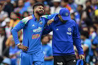 India's Shreyas Iyer (L) reacts in pain after falling on the ground while taking a catch to dismiss Australia's Alex Carey during the third ODI at the Sydney Cricket Ground in Sydney on October 25, 2025.