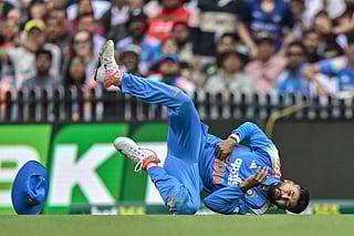 India's Shreyas Iyer falls on the ground after taking a catch to dismiss Australia's Alex Carey during the third ODI match at the Sydney Cricket Ground in Sydney on October 25, 2025.