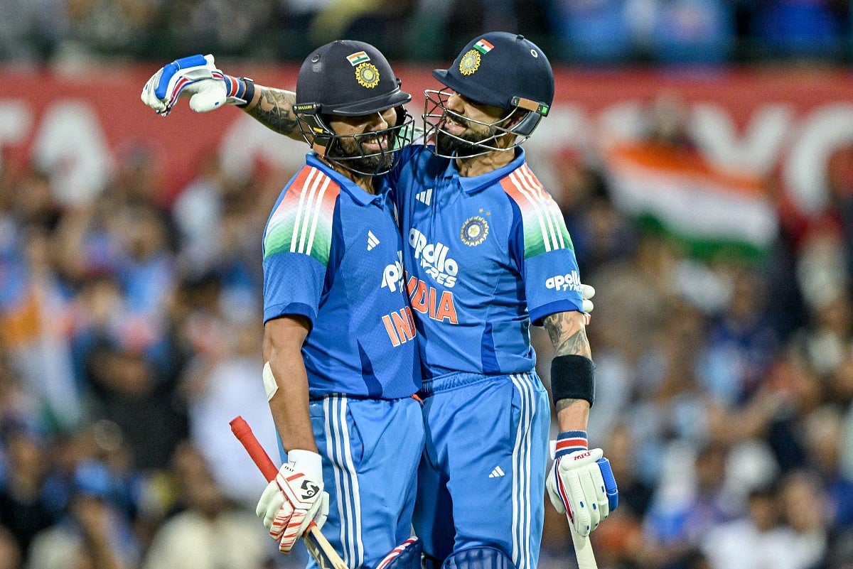 India's Rohit Sharma (L) celebrates with his teammate Virat Kohli after scoring a century during the third ODI against Australia  at the Sydney Cricket Ground in Sydney on October 25, 2025.