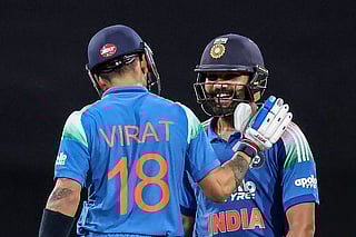 India's Rohit Sharma (R) celebrates with his teammate Virat Kohli after scoring a century (100 runs) during the third one-day international (ODI) men's cricket match between Australia and India at the Sydney Cricket Ground in Sydney on October 25, 2025.