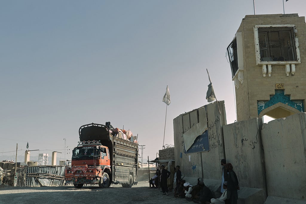 People wait near the closed gate at the Spin Boldak border crossing with Pakistan, after the border was shut for nearly two weeks following clashes between Afghan and Pakistani forces, in Kandahar province, Afghanistan on October 23, 2025.