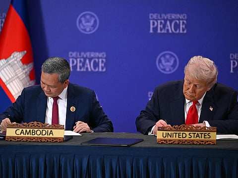 US President Donald Trump (R) and Cambodia's Prime Minister Hun Manet sign documents during a ceremonial signing of a ceasefire agreement between Cambodia and Thailand on the sidelines of the 47th Association of Southeast Asian Nations (ASEAN) Summit in Kuala Lumpur on October 26, 2025. 