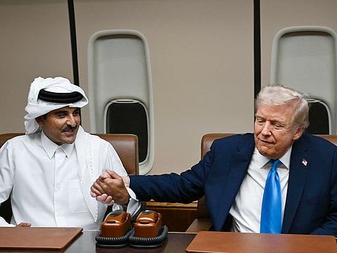 US President Donald Trump meets Qatar’s Emir Sheikh Tamim bin Hamad Al Thani (L) and Prime Minister and Foreign Minister Sheikh Mohammed bin Abdulrahman bin Jassim Al Thani (R) aboard Air Force One in Doha on October 25, 2025, as he makes a refuelling stop on his way to Malaysia for the ASEAN summit. 