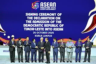 East Timor's Prime Minister Xanana Gusmao (5th L) shakes hands with Malaysia's Prime Minister Anwar Ibrahim (C) after East Timor joined the the Association of Southeast Asian Nations (ASEAN) during the ASEAN Summit in Kuala Lumpur on October 26, 2025.