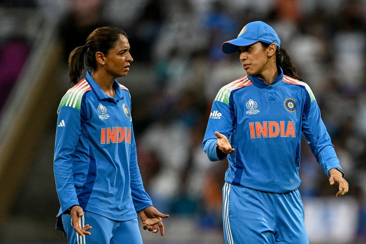 India's Smriti Mandhana (R) speaks with captain Harmanpreet Kaur during the ICC Women's Cricket World Cup 2025 one-day international (ODI) match between India and Bangladesh at the DY Patil Stadium in Navi Mumbai on October 26, 2025.