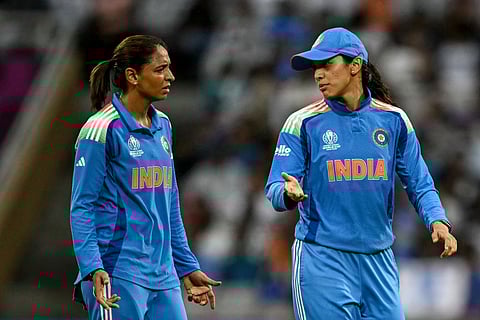 India's Smriti Mandhana (R) speaks with captain Harmanpreet Kaur during the ICC Women's Cricket World Cup 2025 one-day international (ODI) match between India and Bangladesh at the DY Patil Stadium in Navi Mumbai on October 26, 2025.