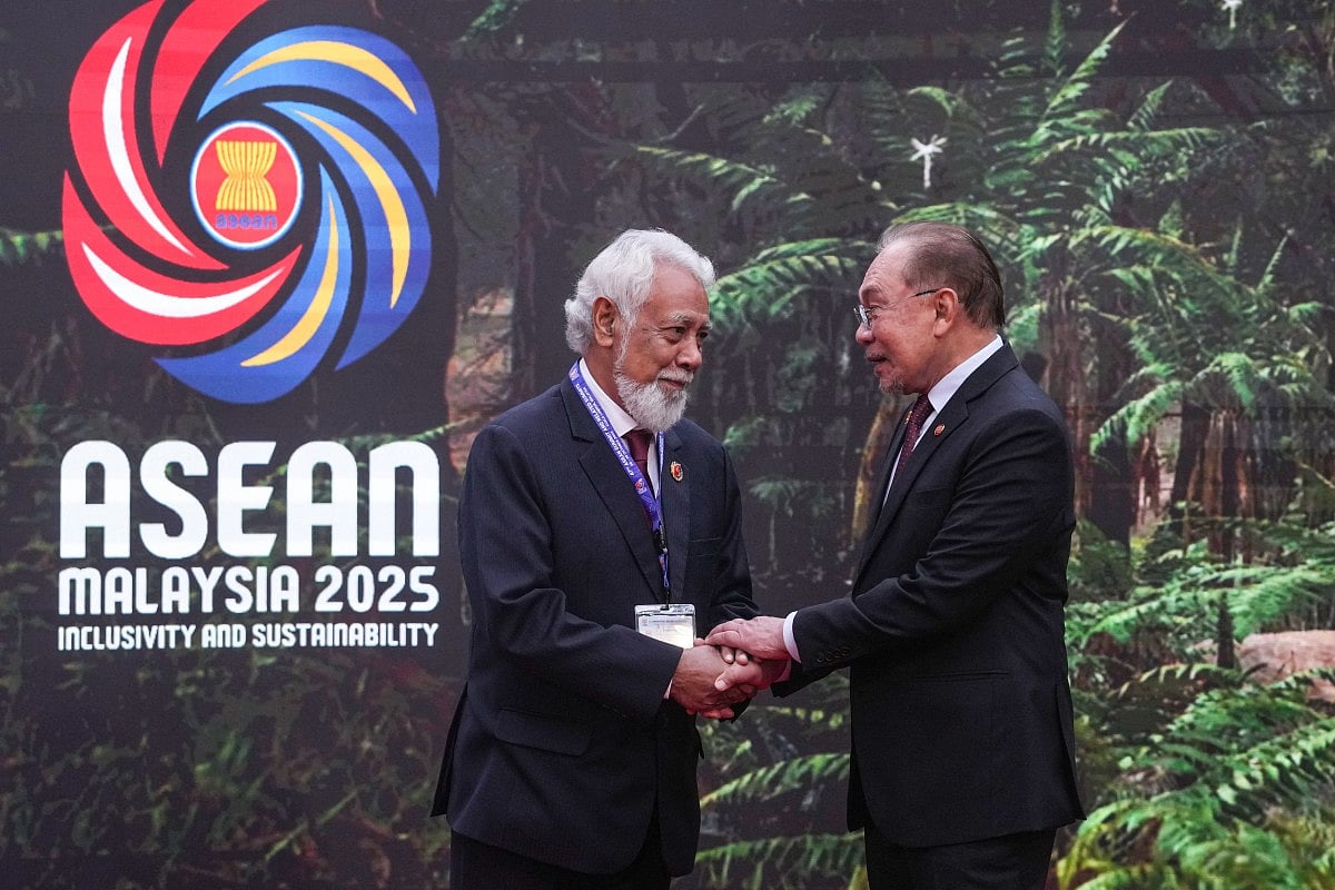 Malaysia's Prime Minister Anwar Ibrahim (R) greets East Timor's Prime Minister Xanana Gusmao as he arrives to attend the 47th Association of Southeast Asian Nations (ASEAN) Summit in Kuala Lumpur on October 26, 2025.