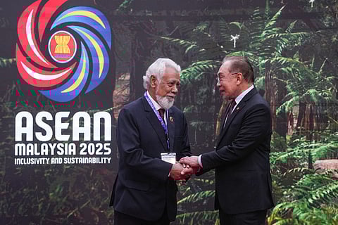 Malaysia's Prime Minister Anwar Ibrahim (R) greets East Timor's Prime Minister Xanana Gusmao as he arrives to attend the 47th Association of Southeast Asian Nations (ASEAN) Summit in Kuala Lumpur on October 26, 2025.