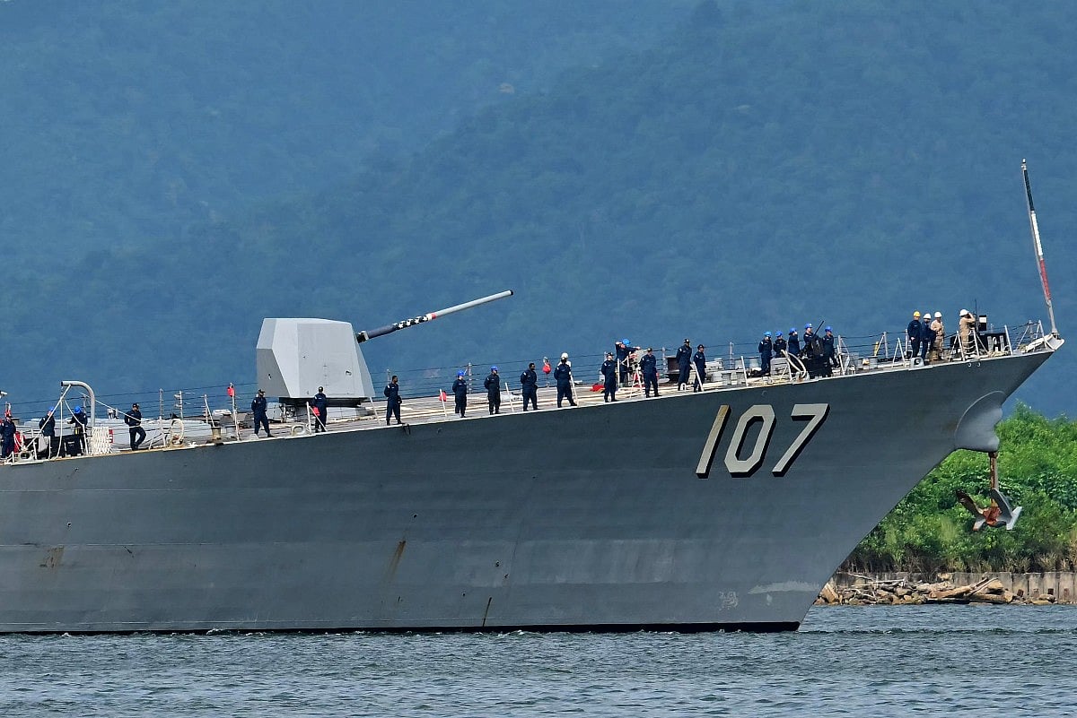 Crew of the USS Gravely warship stand on the bow of the vessel as it enters the port of Port of Spain on October 26, 2025.