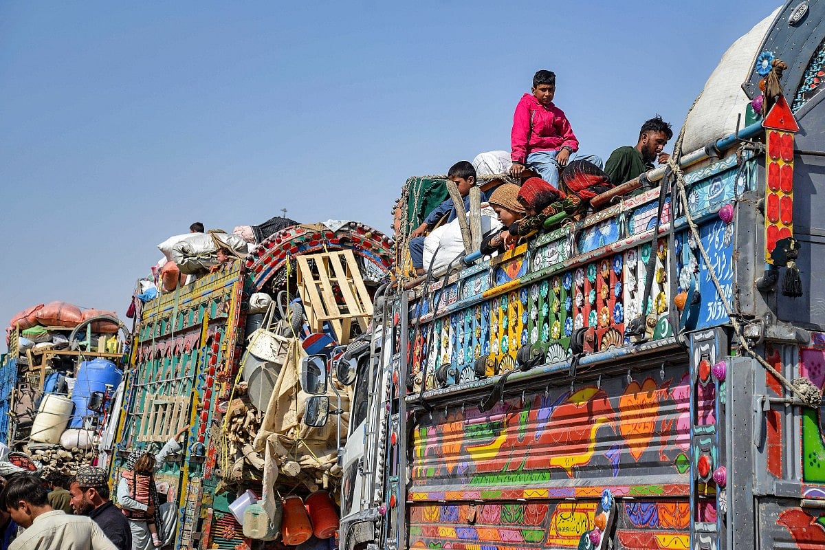 Afghan refugees deported from Pakistan arrive at the zero-point border crossing between Afghanistan and Pakistan, in the Spin Boldak district of Kandahar province on October 27, 2025.