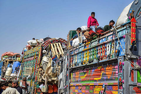 Afghan refugees deported from Pakistan arrive at the zero-point border crossing between Afghanistan and Pakistan, in the Spin Boldak district of Kandahar province on October 27, 2025.