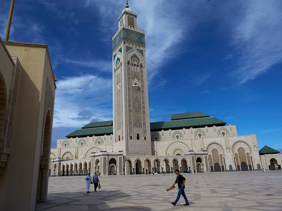 People walk past the great Hassan II Mosque in Casablanca, Morocco