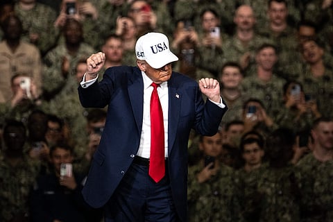 US President Donald Trump dances as he arrives to deliver a speech in front of US Navy personnel on board the US Navy's USS George Washington aircraft carrier at the US naval base in Yokosuka.