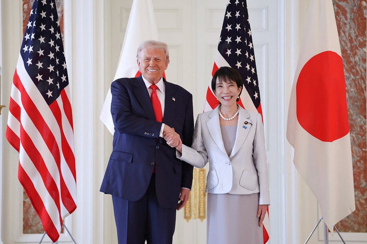 Japan's Prime Minister Sanae Takaichi (R) shakes hands with US President Donald Trump at the Akasaka State Guest House in Tokyo on October 28, 2025.