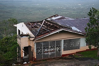 A house with a damaged roof is seen after the passage of Hurricane Melissa in Manchester, Jamaica.