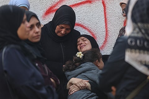 Palestinians mourn the death of loved ones killed in overnight Israeli strikes at the Al Shifa Hospital in Gaza City on October 29, 2025.
