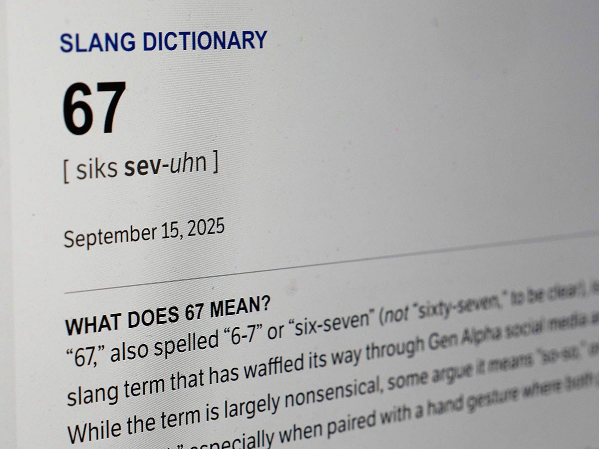 This Dictionary.com page shows the newest word of the year '6 7' on a computer screen.