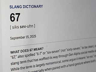 This Dictionary.com page shows the newest word of the year '6 7' on a computer screen.