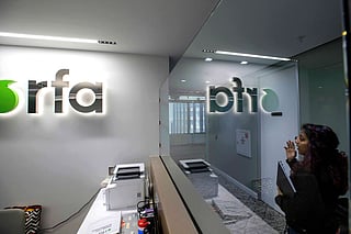 FILE - A woman walks past the empty receptionist desk at Radio Free Asia, April 1, 2025, in Washington. 