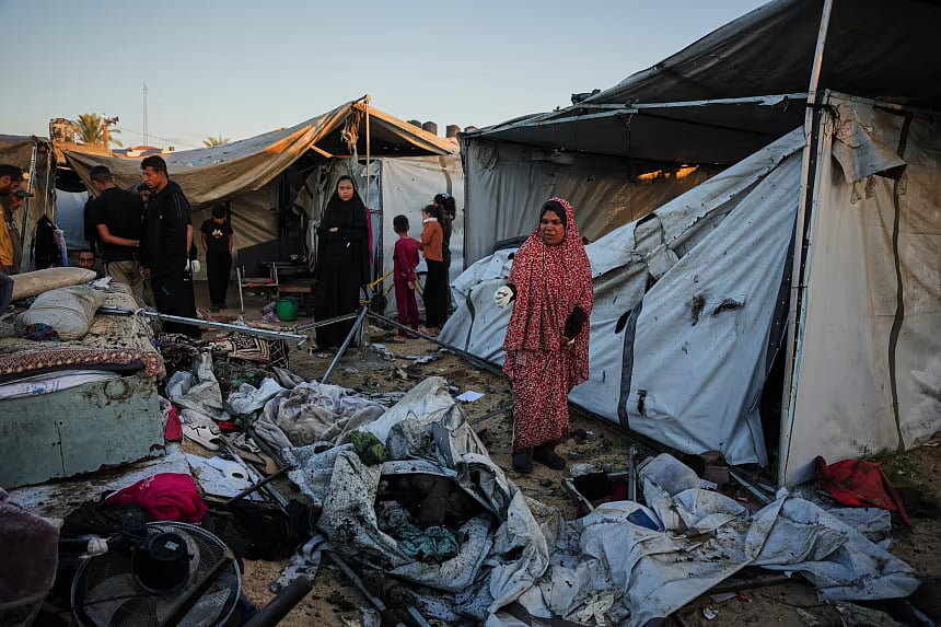 Displaced Palestinians inspect the damage after an Israeli army strike on their tent camp in Deir al-Balah, Gaza Strip, on October 29, 2025.