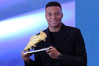 Real Madrid's French forward Kylian Mbappe holds his trophy after receiving the 2024-25 European Golden Shoe award honoring the year's leading goalscorer during a ceremony at Santiago Bernabeu Stadium in Madrid on October 31, 2024.