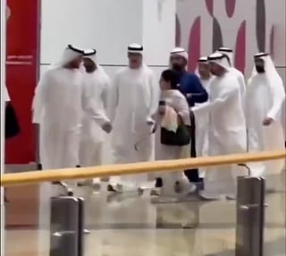 Short video clip shows Sheikh Mohammed walking with his security detail and a group of officials when a woman, seemingly unaware of his presence, crosses directly in front of him. 