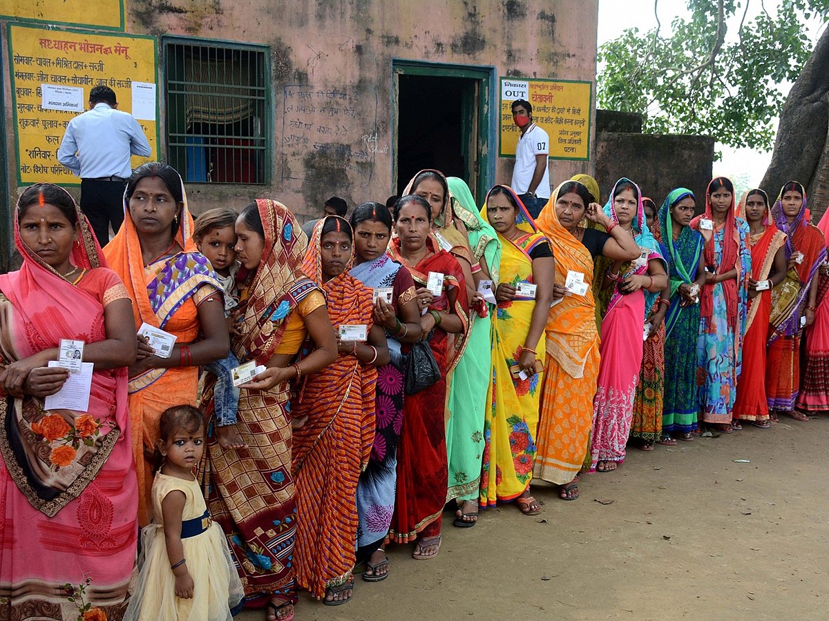 Women stand in a queue to cast their votes in the Bihar panchayat election at Naubatpur, Patna, on October 8, 2021. 