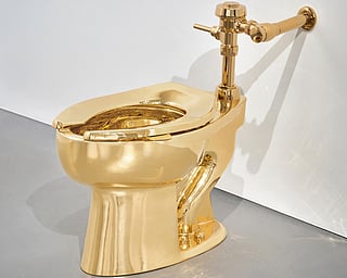 Sotheby’s has announced it will auction a solid gold toilet, a sculpture by Italian artist Maurizio Cattelan called “America.” The auction is set for Nov. 18 in New York. (Sotheby via AP)