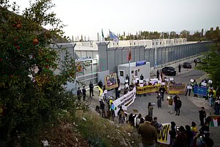 Human rights activists from Italy, Albania and other European countries, gather as they protest against the migrant camps built under a deal between Rome and Tirana outside the Italian-run detention centre in Gjader, near the city of Lezhe, on November 1, 2025.