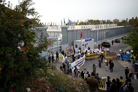 Human rights activists from Italy, Albania and other European countries, gather as they protest against the migrant camps built under a deal between Rome and Tirana outside the Italian-run detention centre in Gjader, near the city of Lezhe, on November 1, 2025.