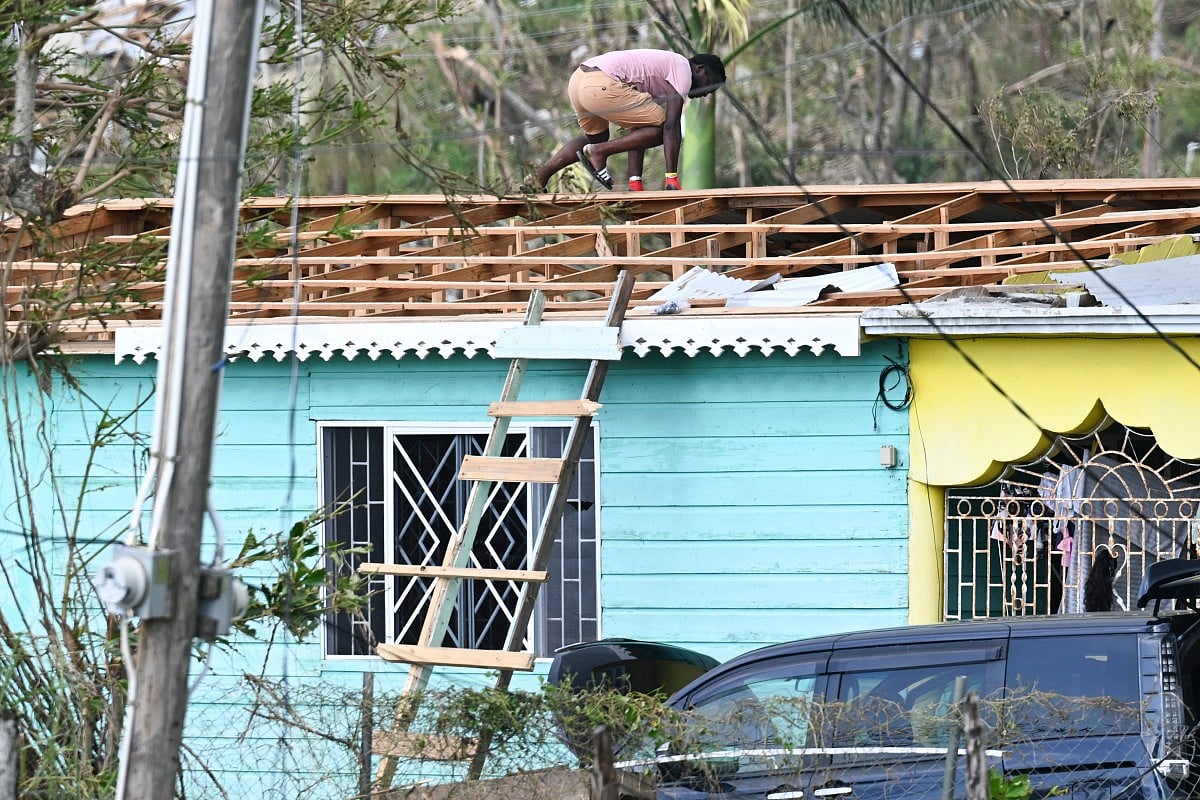 A resident inspects damaged property in the aftermath of Hurricane Melissa in the community of Cave in Westmoreland, Jamaica, on October 31, 2025.