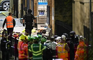 Police and Emergency workers pass a Police cordon outside Huntingdon Station in Huntingdon following a stabbing on a train.