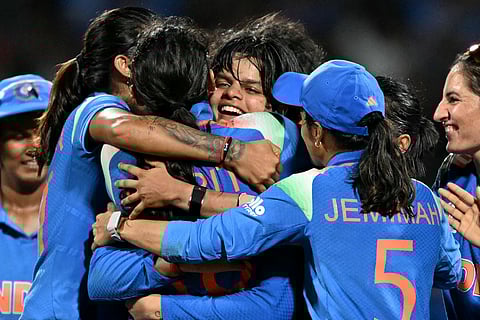India's Shafali Verma (C) celebrates with teammates after taking the wicket of South Africa's Sune Luus during the ICC Women's Cricket World Cup 2025 final at the DY Patil Stadium in Navi Mumbai on November 2, 2025.