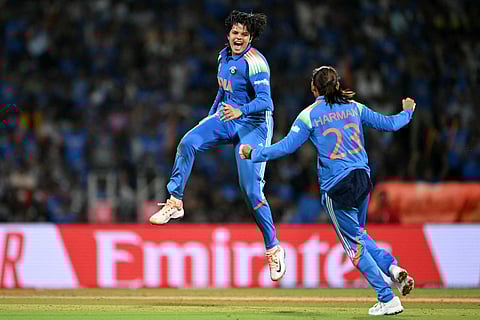 India's Shafali Verma (L) celebrates with her team captain Harmanpreet Kaur after taking the wicket of South Africa's Marizanne Kapp during the ICC Women's Cricket World Cup 2025 one-day international (ODI) final match at the DY Patil Stadium in Navi Mumbai on November 2, 2025.