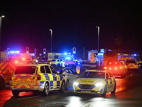 Police cars and Ambulances are pictured outside Huntingdon Station in Huntingdon, eastern England, on November 1, 2025, following a stabbing on a train.