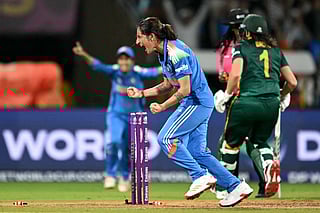 India's Renuka Singh celebrates after the dismissal of South Africa's Tazmin Brits (R) during the ICC Women's Cricket World Cup 2025 one-day international (ODI) final match between India and South Africa at the DY Patil Stadium in Navi Mumbai on November 2, 2025.
