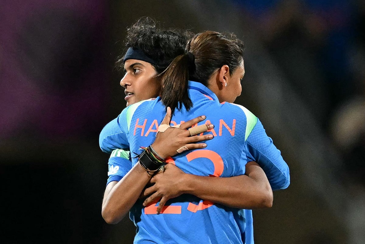 India's Shree Charani (L) celebrates with her team captain Harmanpreet Kaur after taking the wicket of South Africa's Anneke Bosch during the ICC Women's Cricket World Cup 2025 one-day international (ODI) final match between India and South Africa at the DY Patil Stadium in Navi Mumbai on November 2, 2025.