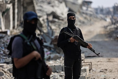 Hamas militants guard an area where they are searching for the bodies of hostages with the help of the International Committee of the Red Cross (ICRC) in Gaza City on November 3, 2025.
