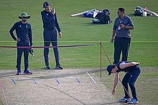 South Africa's captain Matthew Breetzke (R), along with teammates, inspects the pitch during a practice session on the eve of their first one-day international (ODI) cricket match against Pakistan at the Iqbal Cricket Stadium in Faisalabad on November 3, 2025.