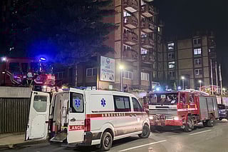 A rescue cars are parked in front of a nursing home after a fire in Tuzla, Bosnia, Tuesday, Nov. 4, 2025. 