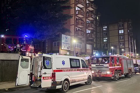 A rescue cars are parked in front of a nursing home after a fire in Tuzla, Bosnia, Tuesday, Nov. 4, 2025. 